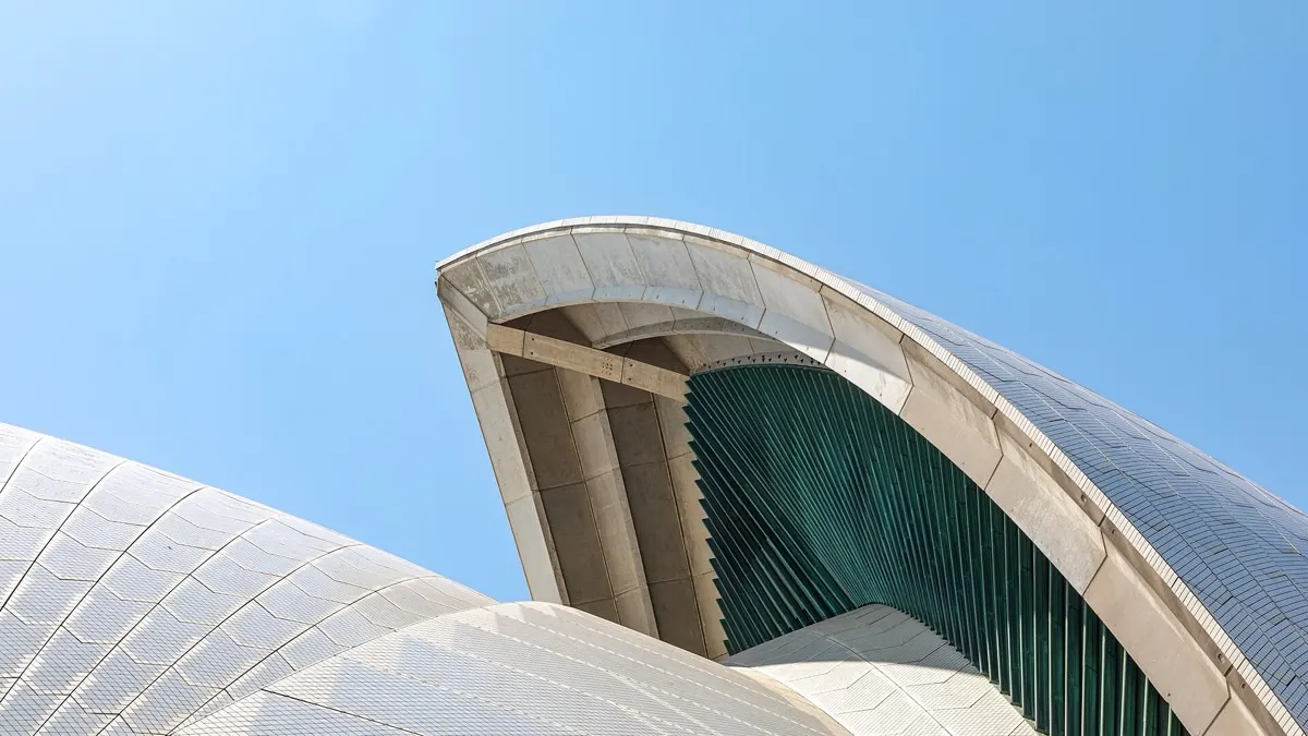 Sydney Opera House on the harbour with the city skyline behind