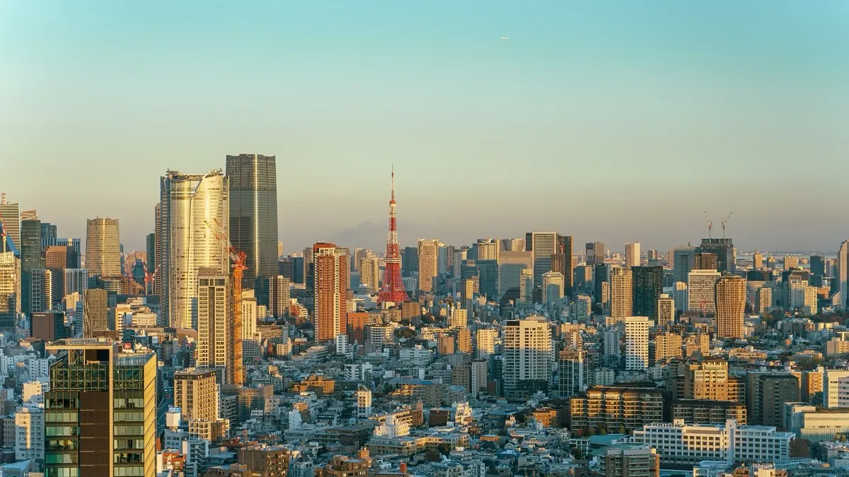 Tokyo skyline at golden hour with Tokyo Tower rising above Minato ward